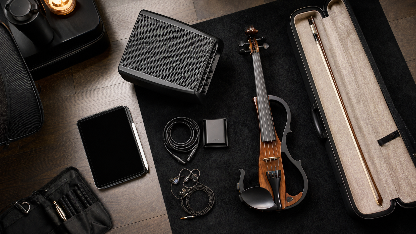 Travel-ready electric violin performance kit с компактен powered monitor speaker, калъф за лък, кабели, таблет и in-ear monitors, подредени внимателно